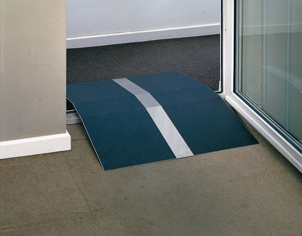 Dark blue ramp with silver strip down the middle, over a doorframe. Cream carpet in one room, an brown in the other. 