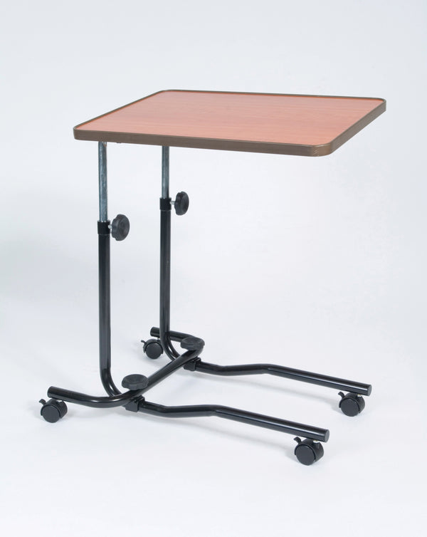 Image shows a wheeled brown desk with curved edges. The silver and black frame is attached on one side, and has four black wheels. This product is shown against a white background. 