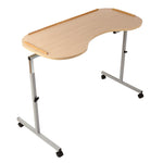 Image shows wooden effect over bed/ chair table, with curved edge where user sits. The product has two grey legs with four black wheels, and ridges on the table to prevent items falling of. Product is shown against a white background. 