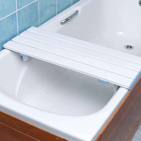 This image shows the white slatted bath board set up across a wooden panelled bath with white lining, in a bathroom with blue tiles. 