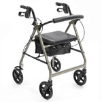Image shows a silver and black 4 wheeled rollator. There is storage covered by a padded seat with a padded bar for back support so the rollator can double up as a chair.