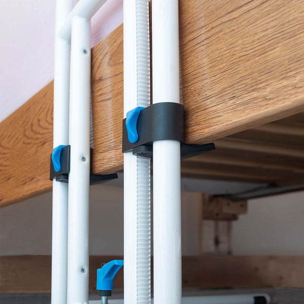This image is a close up view of the black and blue adjustable fasteners that attaches the bed rail to the bed frame. 